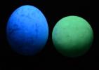 Glowing in the dark bright green sphere and blue egg